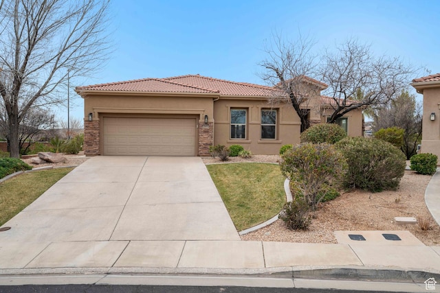 view of front of property with an attached garage, concrete driveway, a tile roof, a front lawn, and stucco siding