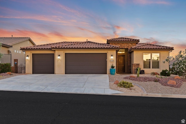 714 N Millcreek Springs Dr, Washington, UT 84780 - mediterranean / spanish-style house featuring stucco siding, a garage, and driveway
