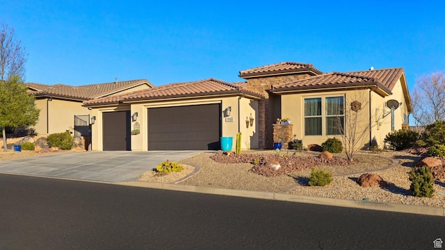 714 N Millcreek Springs Dr, Washington, UT 84780 - mediterranean / spanish-style home with an attached garage, stucco siding, a tiled roof, and driveway