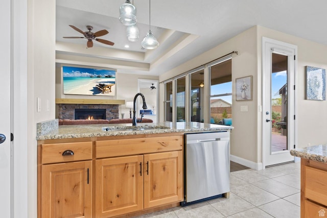 714 N Millcreek Springs Dr, Washington, UT 84780 - kitchen with dishwasher, a sink, ceiling fan, a stone fireplace, and light stone countertops
