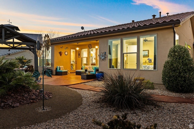 714 N Millcreek Springs Dr, Washington, UT 84780 - rear view of property with stucco siding, outdoor lounge area, and a patio