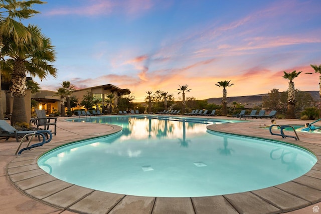 714 N Millcreek Springs Dr, Washington, UT 84780 - pool at dusk featuring a patio area and a community pool