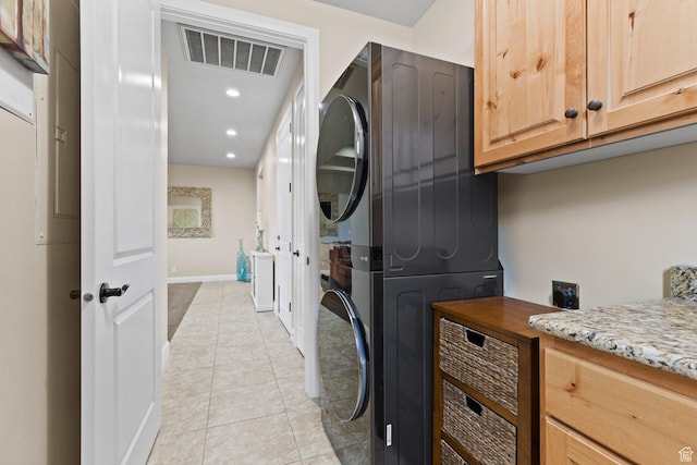 714 N Millcreek Springs Dr, Washington, UT 84780 - washroom with stacked washer and clothes dryer, cabinet space, light tile patterned floors, baseboards, and recessed lighting