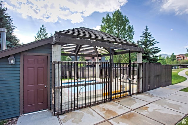 6861 N 2200 W Unit 9D, Park City, UT 84098 - view of gate featuring a pergola, fence, and a fenced in pool