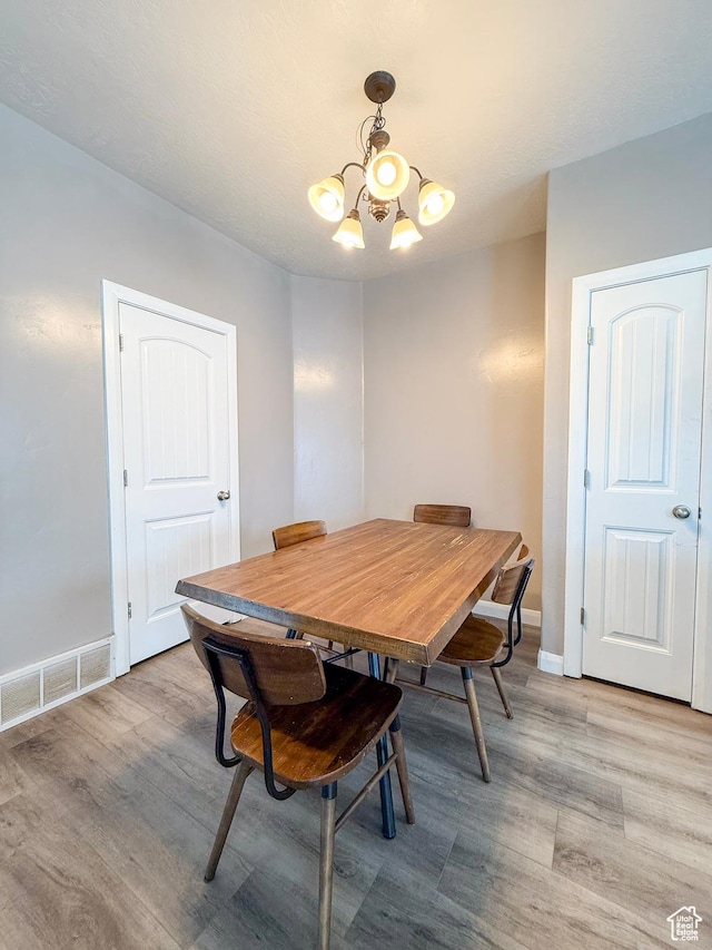 2016 E Cedar Trails Way, Eagle Mountain, UT 84005 - dining space featuring a chandelier, light wood-type flooring, and baseboards