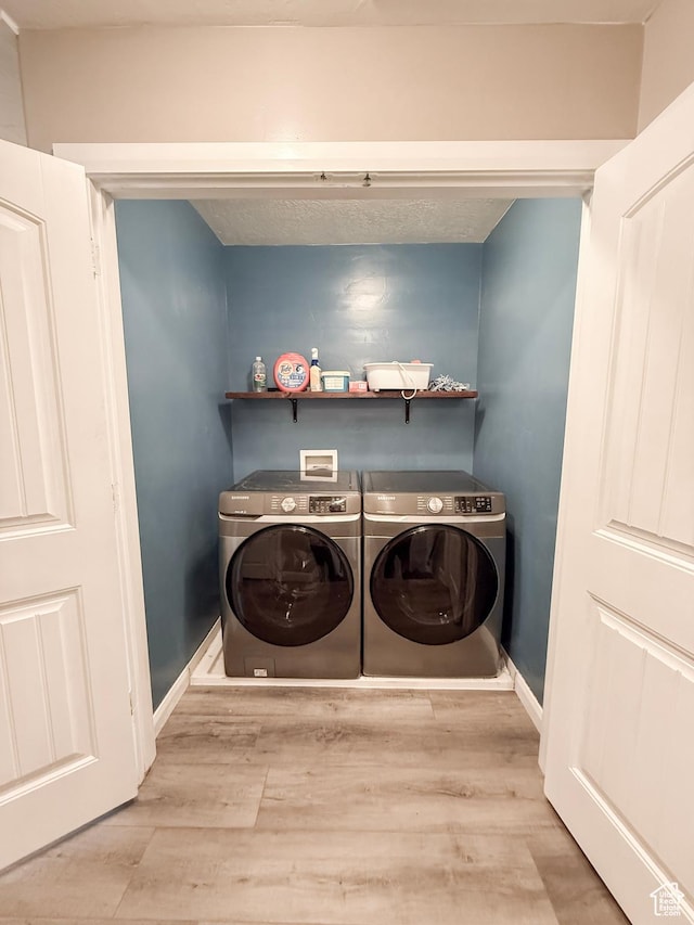 2016 E Cedar Trails Way, Eagle Mountain, UT 84005 - clothes washing area with washer and dryer, wood finished floors, and baseboards