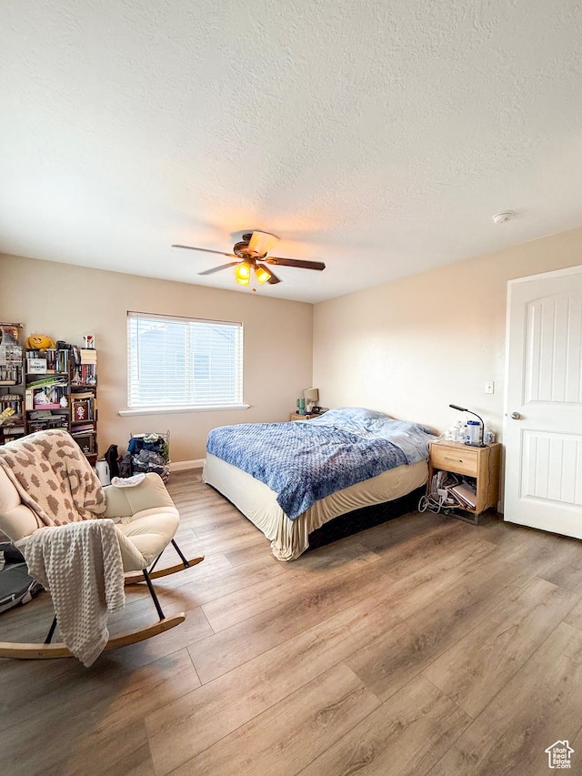 2016 E Cedar Trails Way, Eagle Mountain, UT 84005 - bedroom featuring wood finished floors, a textured ceiling, and a ceiling fan