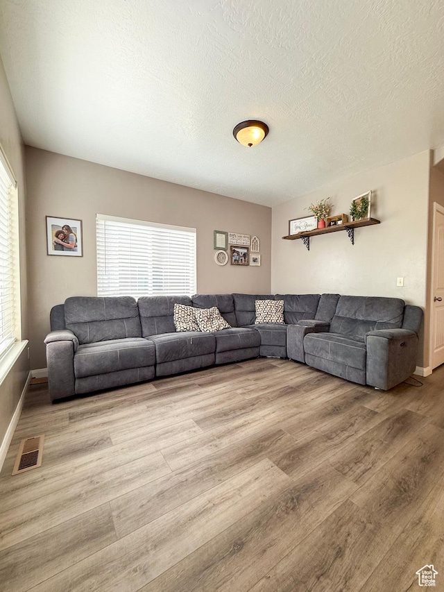 2016 E Cedar Trails Way, Eagle Mountain, UT 84005 - living area featuring wood finished floors, baseboards, and a textured ceiling