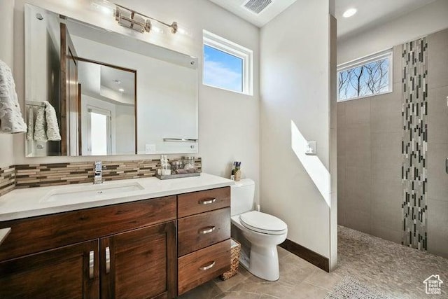 3052 N Snow Canyon Pkwy Unit 36, St George, UT 84770 - bathroom featuring toilet, a walk in shower, vanity, tasteful backsplash, and visible vents