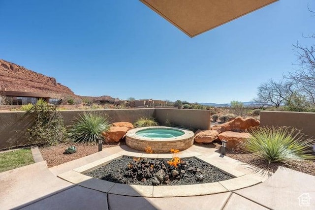 3052 N Snow Canyon Pkwy Unit 36, St George, UT 84770 - view of patio / terrace featuring an in ground hot tub and fence