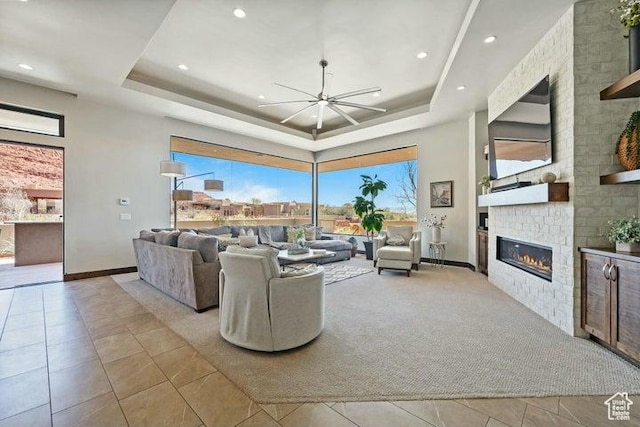 3052 N Snow Canyon Pkwy Unit 36, St George, UT 84770 - carpeted living area with a ceiling fan, tile patterned floors, a tray ceiling, and a fireplace