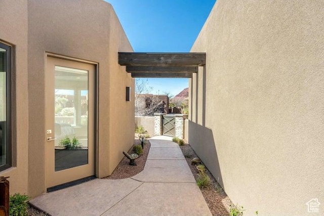 3052 N Snow Canyon Pkwy Unit 36, St George, UT 84770 - doorway to property with stucco siding, a gate, and a patio area
