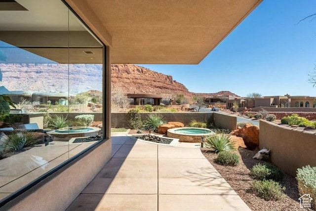 3052 N Snow Canyon Pkwy Unit 36, St George, UT 84770 - view of patio featuring an in ground hot tub