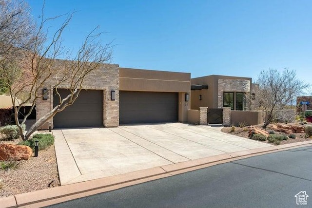 3052 N Snow Canyon Pkwy Unit 36, St George, UT 84770 - southwest-style home featuring driveway, stone siding, an attached garage, and stucco siding