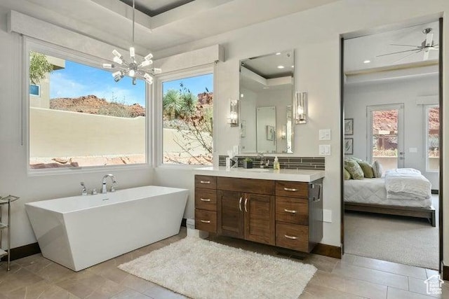 3052 N Snow Canyon Pkwy Unit 36, St George, UT 84770 - ensuite bathroom featuring a notable chandelier, connected bathroom, vanity, and a wealth of natural light