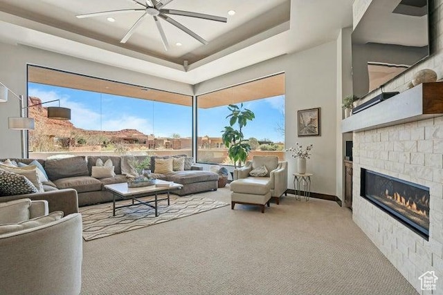 3052 N Snow Canyon Pkwy Unit 36, St George, UT 84770 - living room with a tray ceiling, carpet floors, a high ceiling, a glass covered fireplace, and ceiling fan