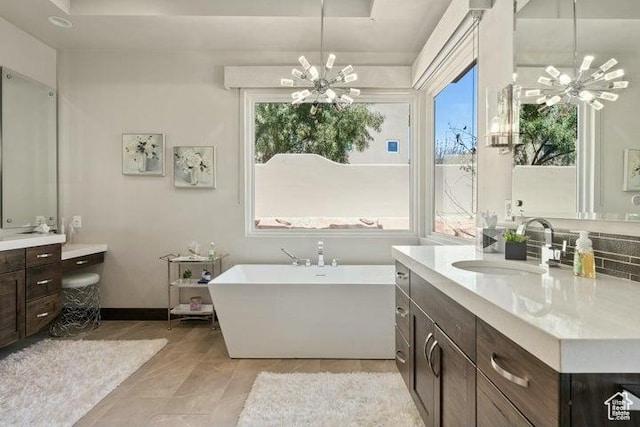 3052 N Snow Canyon Pkwy Unit 36, St George, UT 84770 - full bath featuring a freestanding tub, a tray ceiling, vanity, and an inviting chandelier