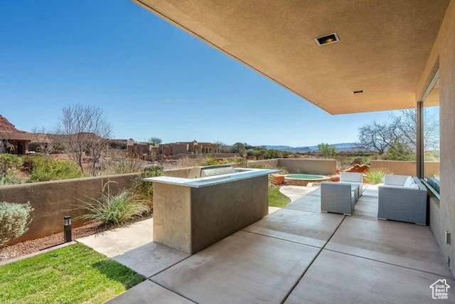 3052 N Snow Canyon Pkwy Unit 36, St George, UT 84770 - view of patio featuring an in ground hot tub and visible vents