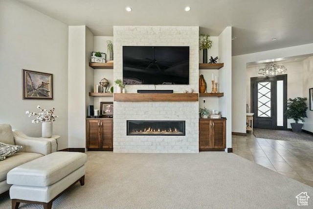 3052 N Snow Canyon Pkwy Unit 36, St George, UT 84770 - tiled living area featuring baseboards, a large fireplace, built in features, and carpet