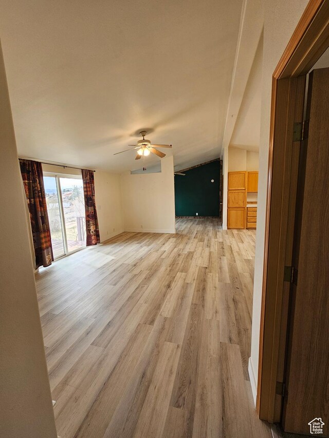 2350 S Red Creek Rd, Fruitland, UT 84027 - unfurnished living room featuring baseboards, light wood-type flooring, and a ceiling fan