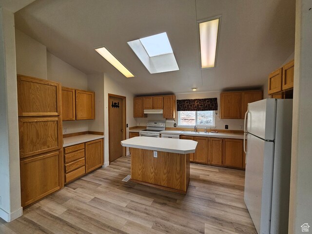 2350 S Red Creek Rd, Fruitland, UT 84027 - kitchen featuring light countertops, white appliances, a center island, light wood-style floors, and lofted ceiling with skylight