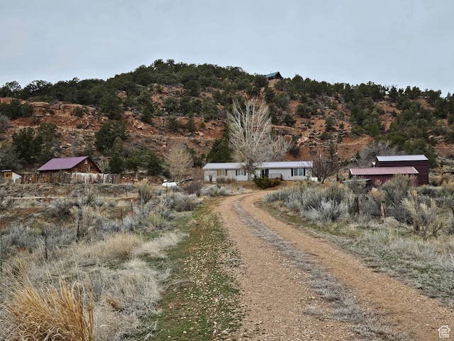 view of street featuring dirt driveway
