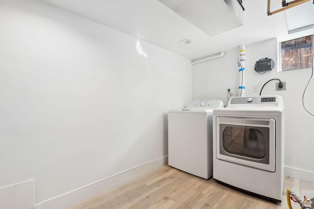 1138 E Hudson Ave, Salt Lake City, UT 84106 - washroom featuring washing machine and clothes dryer, baseboards, light wood finished floors, and laundry area