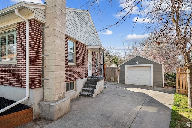 1138 E Hudson Ave, Salt Lake City, UT 84106 - view of home's exterior with fence, a garage, brick siding, driveway, and an outbuilding
