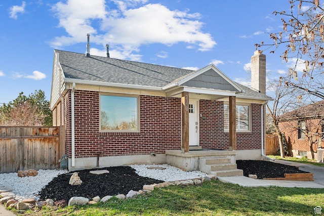 1138 E Hudson Ave, Salt Lake City, UT 84106 - bungalow-style house featuring a chimney, a shingled roof, fence, and brick siding