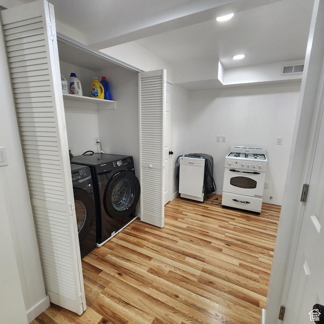 laundry area with visible vents, laundry area, recessed lighting, light wood-style floors, and washer and clothes dryer