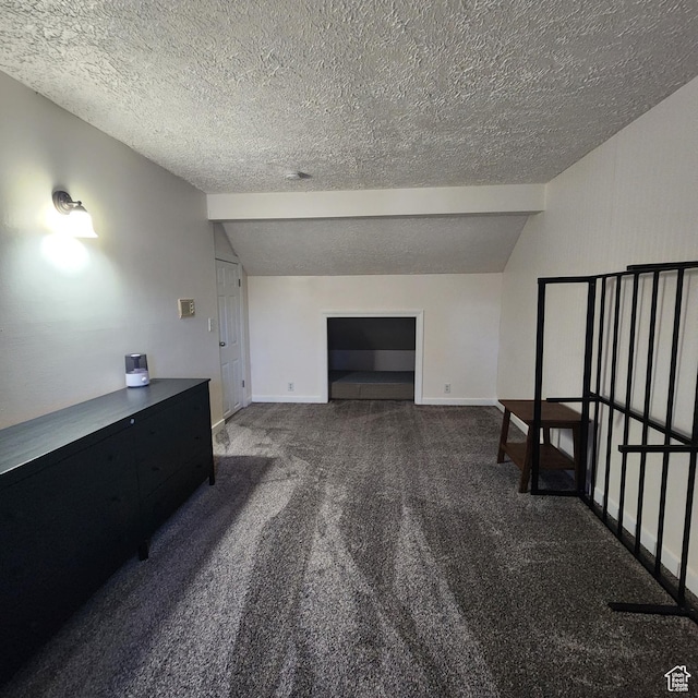 unfurnished living room with baseboards, lofted ceiling, carpet flooring, and a textured ceiling