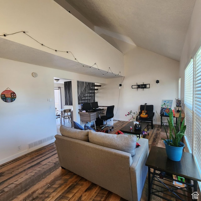 living area with baseboards, high vaulted ceiling, visible vents, and wood finished floors