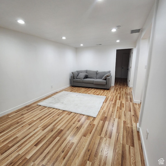 unfurnished living room featuring baseboards, light wood-style floors, and recessed lighting