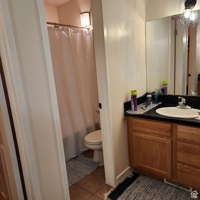 bathroom featuring visible vents, toilet, curtained shower, vanity, and tile patterned flooring