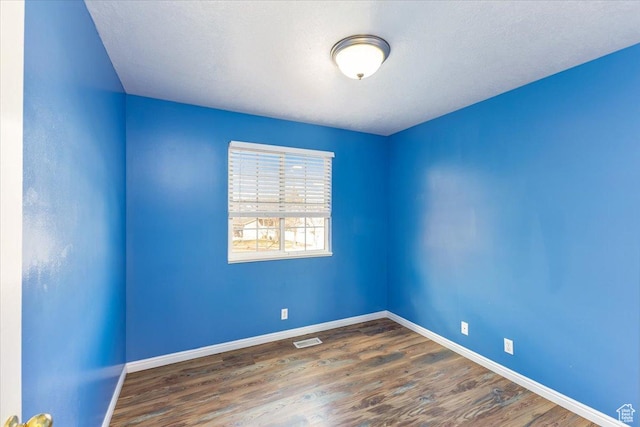 100 Crayon Ct, Logan, UT 84321 - spare room featuring baseboards, wood finished floors, and visible vents