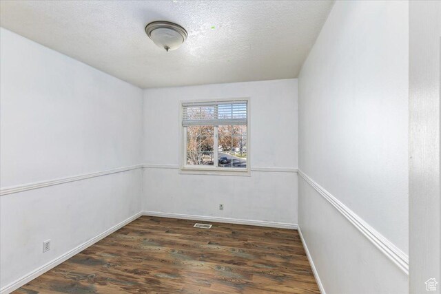 100 Crayon Ct, Logan, UT 84321 - spare room with a textured ceiling, baseboards, wood finished floors, and visible vents