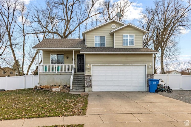 100 Crayon Ct, Logan, UT 84321 - tri-level home with fence, covered porch, a gate, an attached garage, and driveway