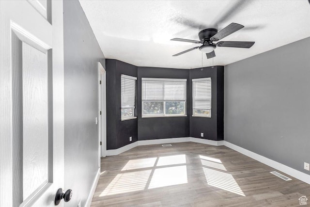 100 Crayon Ct, Logan, UT 84321 - spare room with a ceiling fan, baseboards, visible vents, and wood finished floors