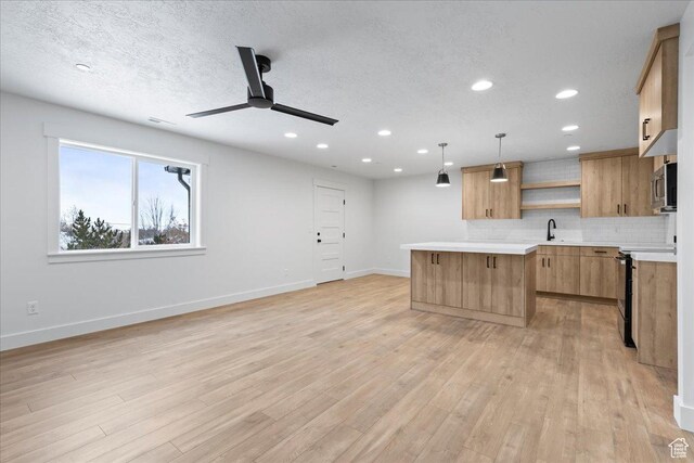 2230 S 635 W Unit B, Perry, UT 84302 - kitchen with a ceiling fan, open shelves, light countertops, and stainless steel microwave