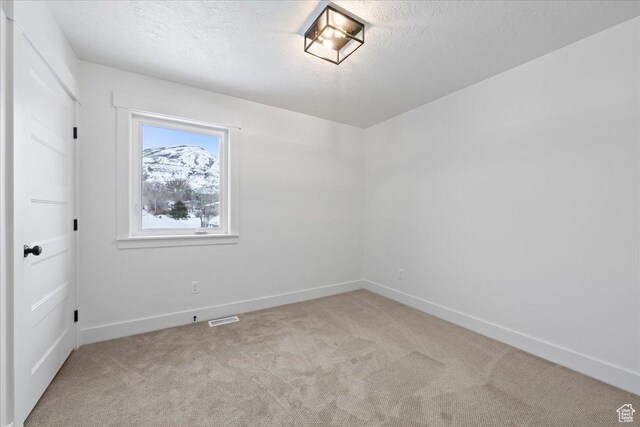 2230 S 635 W Unit B, Perry, UT 84302 - carpeted spare room with baseboards, visible vents, and a textured ceiling