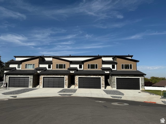 2230 S 635 W Unit B, Perry, UT 84302 - view of front facade with stone siding, driveway, and a garage