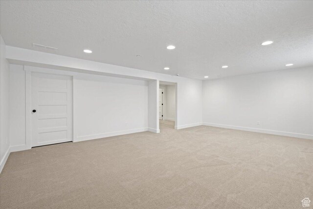 2230 S 635 W Unit B, Perry, UT 84302 - finished below grade area with light carpet, baseboards, recessed lighting, and a textured ceiling