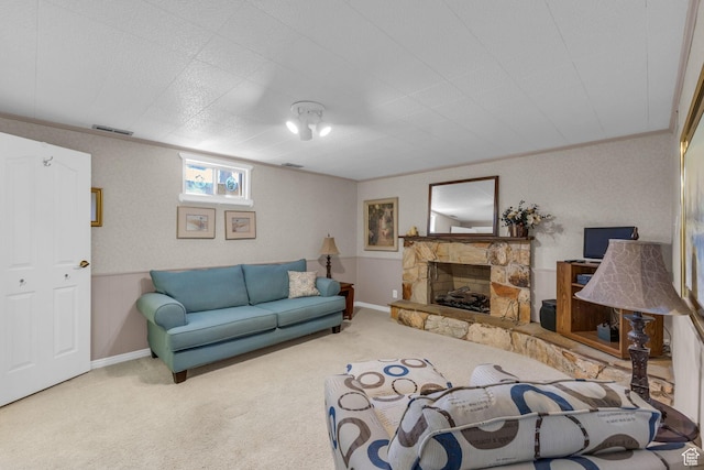 carpeted living area with baseboards, visible vents, and crown molding