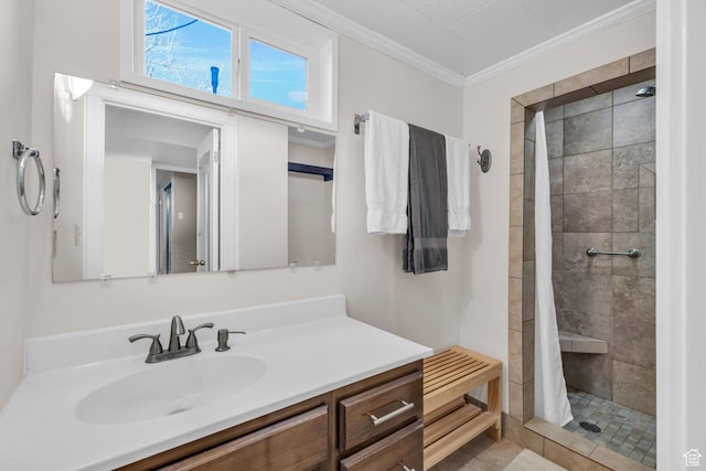 bathroom featuring vanity, tiled shower, and crown molding