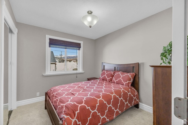 bedroom with baseboards and carpet flooring