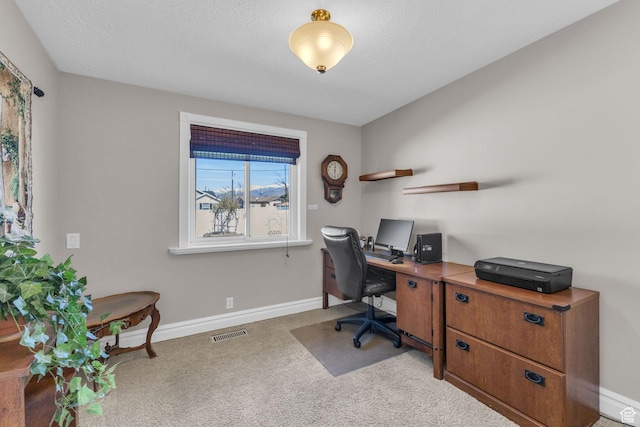 carpeted home office with baseboards and visible vents