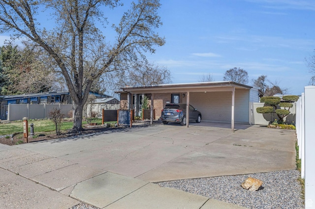 view of front of home with driveway, a carport, a gate, and fence