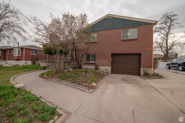 627 W La Salle Dr, Murray, UT 84123 - view of front of house featuring driveway, a garage, and brick siding