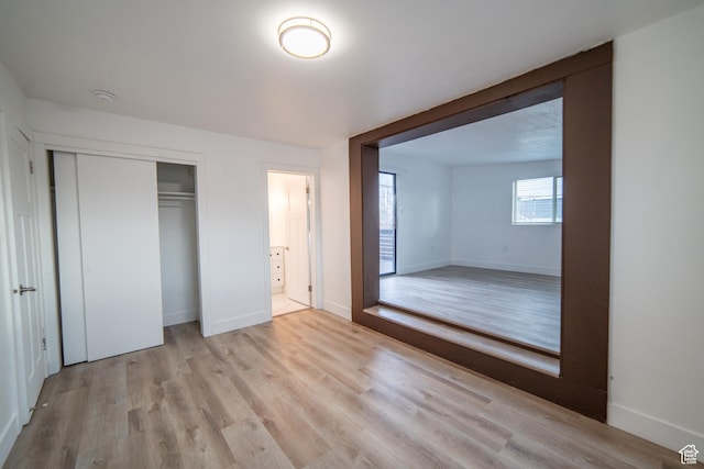 627 W La Salle Dr, Murray, UT 84123 - unfurnished bedroom featuring baseboards, light wood-style flooring, and a closet