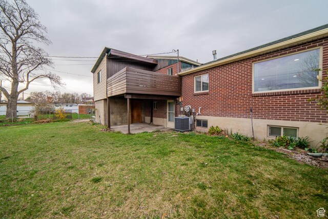 627 W La Salle Dr, Murray, UT 84123 - back of house featuring central AC unit, fence, brick siding, a yard, and a patio area